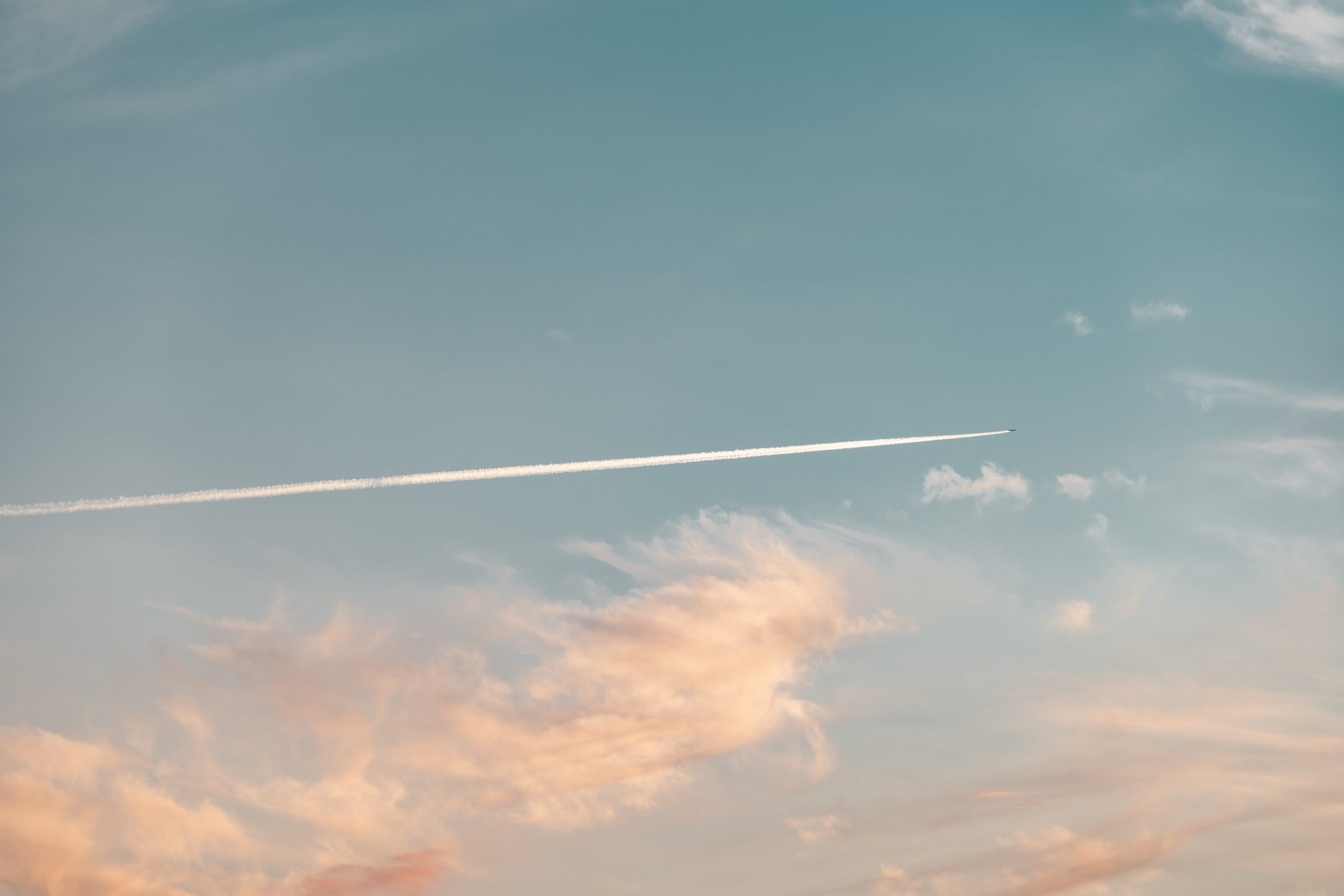 Plane flying in the sky at sunset